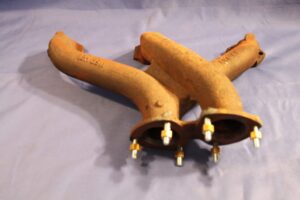 (8) MGB RECONDITIONED RESTUDDED CAST MANIFOLD EXCHANGE