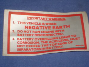 CRST115 WARNING NEGATIVE EARTH STICKER RED & SILVER